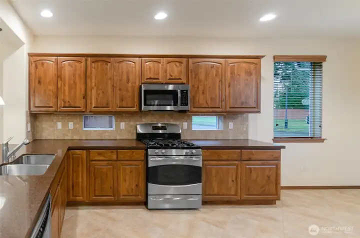 Stainless gas stove.  Notice small recipe windows, which allows natural light.