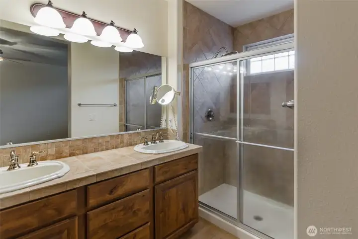 Primary bath en suite.  Expanded tiled shower, dual sinks and private toilet area.