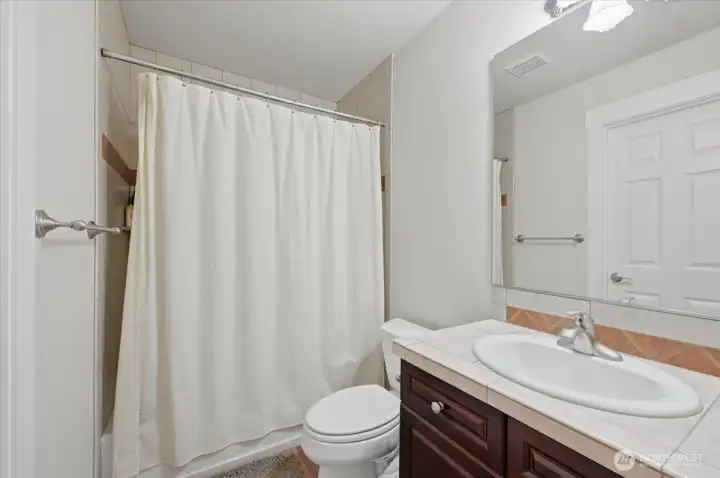 Ensuite bathroom with bath tub and shower