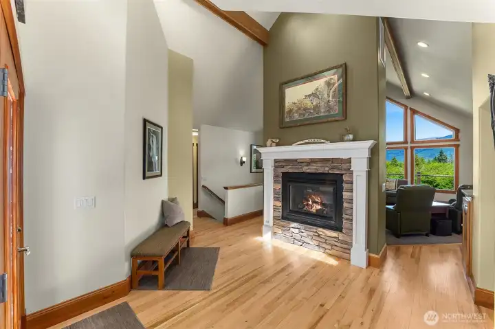 Main home entry is stunning with welcoming double sided fireplace and vaulted ceilings Main home entry is stunning with welcoming double sided fireplace and vaulted ceilings