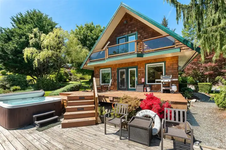 Deck overlooks pond with hot tub. Deck overlooks pond with hot tub.