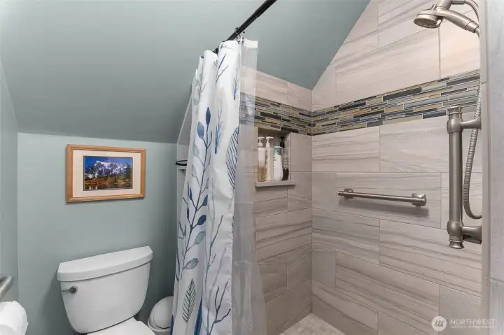 New tile walk in shower. Bathroom also has laundry. New tile walk in shower. Bathroom also has laundry.