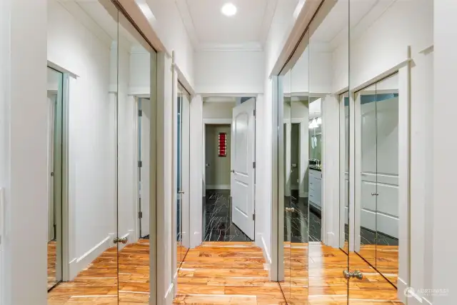 Primary room entrance to bathroom with closet on each side