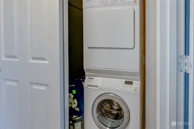 A dedicated laundry space with a convenient stacked washer and dryer. The closet provides efficient storage to keep everything organized.