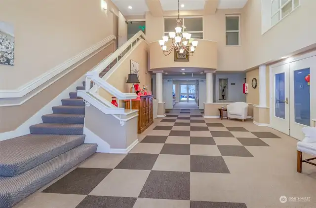 The elegant and welcoming lobby, featuring high ceilings, sophisticated lighting, and a grand staircase. This space sets the tone for the well-maintained and beautifully designed community.