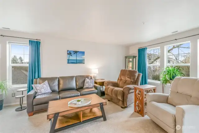 Another view of this stunning living space showcases its functional design and stylish updates. The spacious layout allows for effortless furniture arrangement, while large windows provide peek-a-boo views of Mt. Rainier on clear days. The living room serves as a central gathering area filled with natural light and charm.