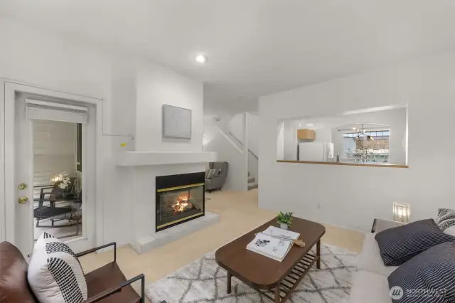 Family & living room share a gas fireplace & high ceilings