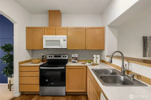 Kitchen has lots of storage. stainless steel range and stainless steel double sink