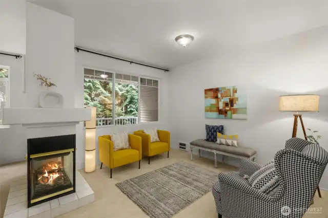 Family & living room share a gas fireplace & high ceilings
