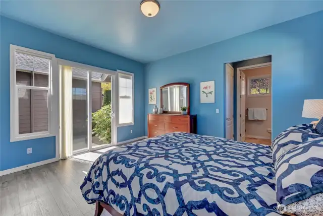 This bedroom also has newer Luxury Vinyl Plank flooring and the slider opens to the courtyard.
