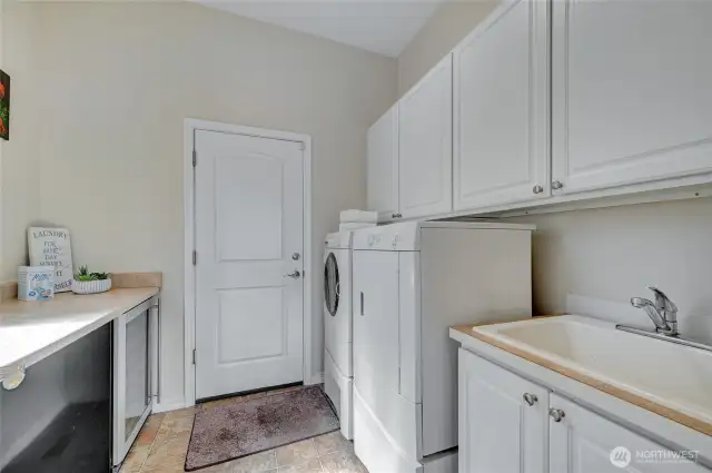 The washer and dryer are included with the home. Additional storage, laundry sink for projects and a folding counter.