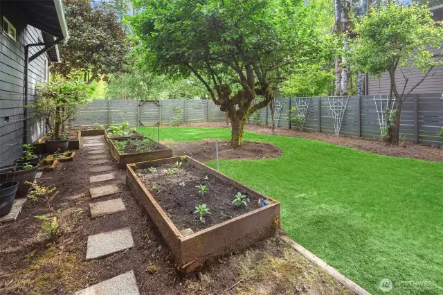 Raised garden beds and fruit trees - your own backyard bounty and a fully fenced private side yard.