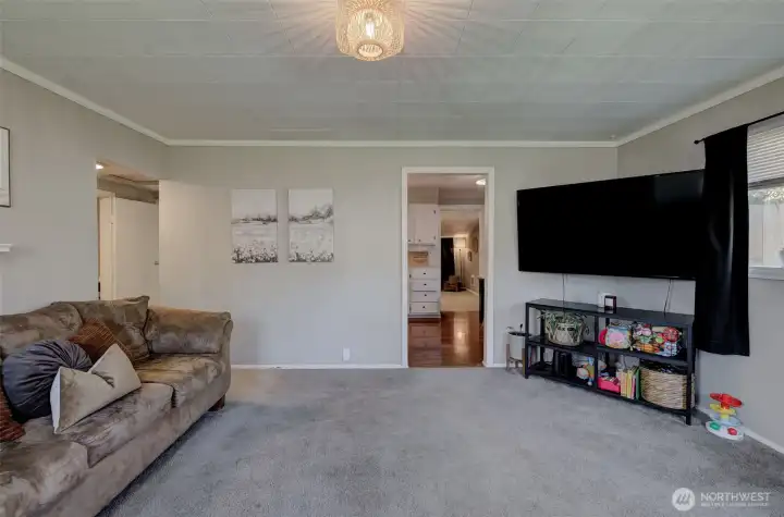 Bright main living area with large windows and comfortable gathering space.