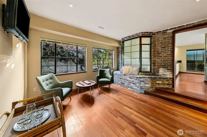 This quiet sitting area wrapped in stamped Venetian plaster steps down toward a wall of commercial steel windows that frame the courtyard garden. Just beyond is the 500 SF garage with its own set of large steel windows, dual radiant heaters and mechanical infrastructure. The space sits close to the utility room with terrazzo flooring, specialty tile and service systems that reflect the home’s thoughtful, well-crafted design.