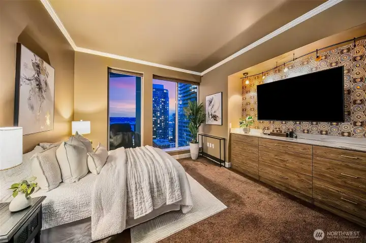 large primary with walk in closet  floor to ceiling windows faces western water and city views