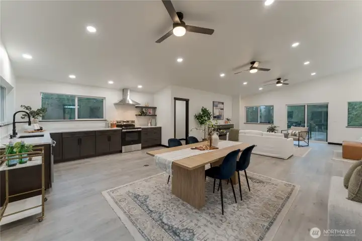 Open-concept living, dining, and kitchen with high ceilings. Wired for island