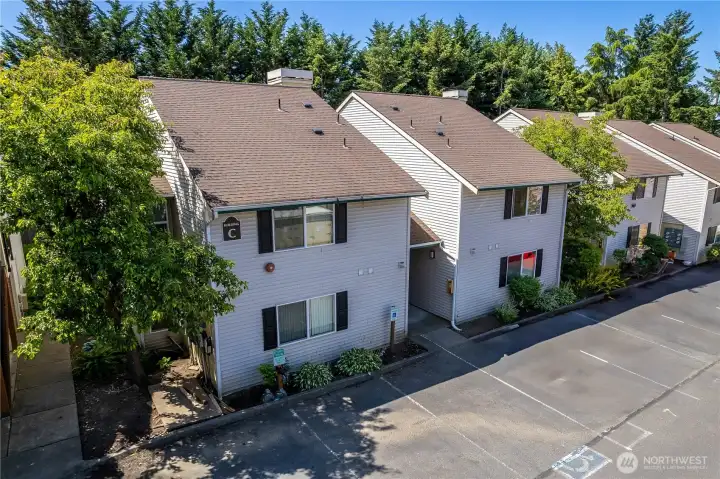 Aerial view showing the building, parking and surrounding neighborhood.