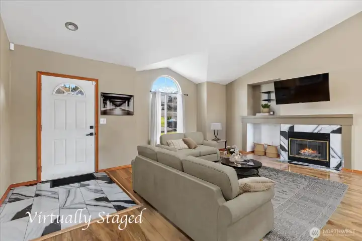 Spacious living room with gas fireplace and vaulted ceilings.
