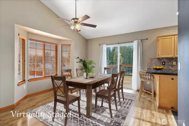 Dining area off the living room is vaulted with bay window and slider.