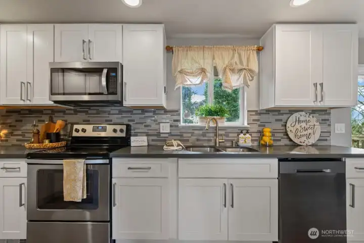 See a greenbelt of trees while looking out your kitchen window.