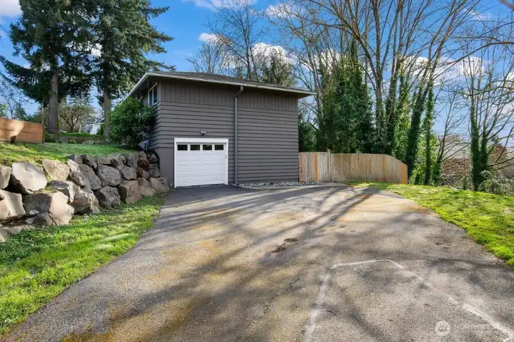 A full-sized SUV fits in that one car garage.  Otherwise, you have a lot of room for parking on this large driveway area.