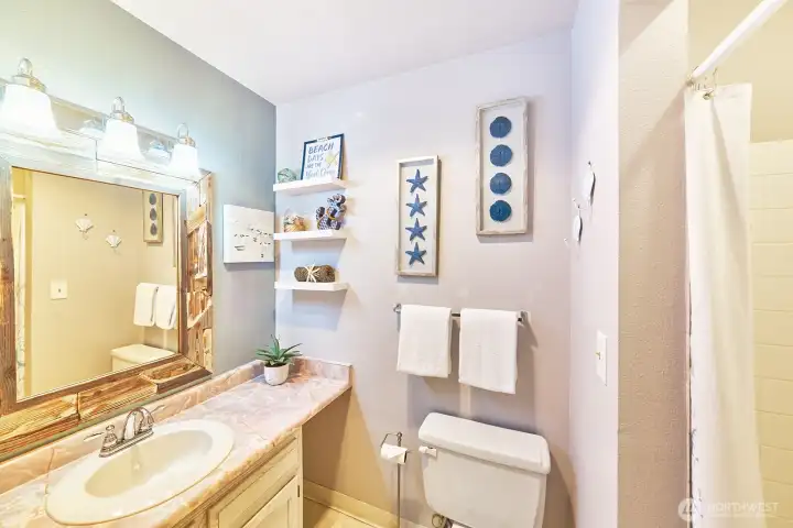 Clean and functional 3/4 bath with step-in shower.