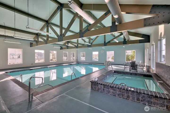 Swim, soak, and recharge in the spacious indoor pool area with hot tub.