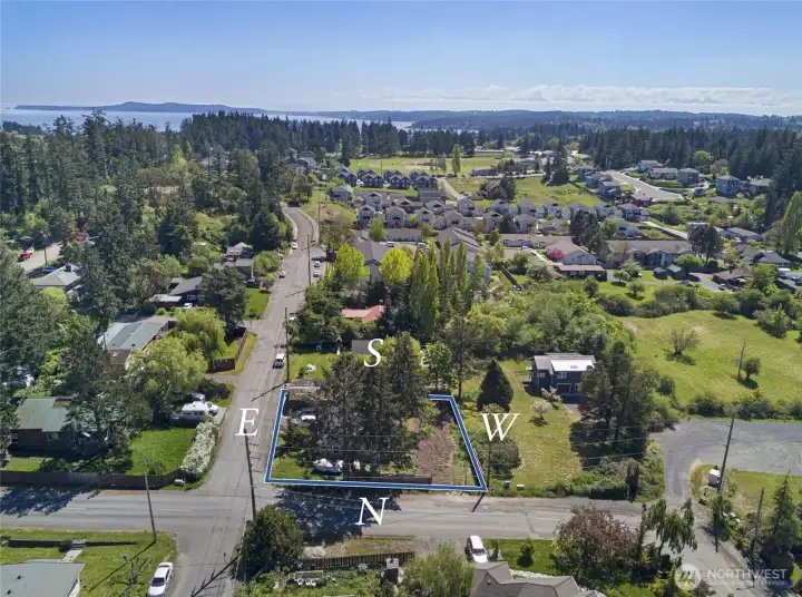 Oriented on a corner lot with favorable north and east street frontage, this well-positioned property sits perched above the surrounding streetscape, offering privacy and easy circulation in all directions within this charming residential enclave.