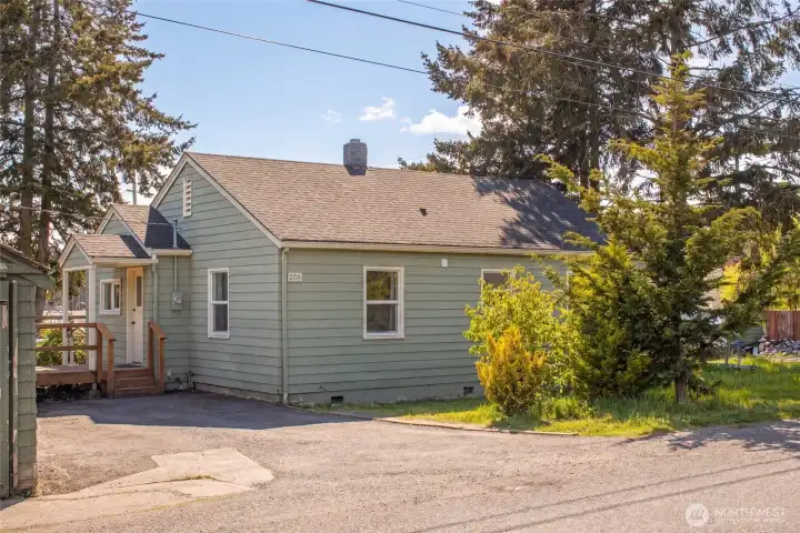 Freshly painted in classic sage green with crisp white trim, this 1940 single-level charmer at 205 Franck Street sits proudly on a corner lot surrounded by mature evergreens, with a welcoming front entry and ample off-street parking. The home's coveted walkable location is just minutes from Friday Harbor's vibrant waterfront, ferry landing, and town amenities.