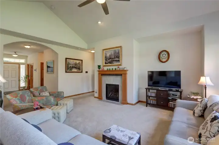 Relaxing, Vaulted Great Room features a gas fireplace, fan-light and recessed entertainment space.