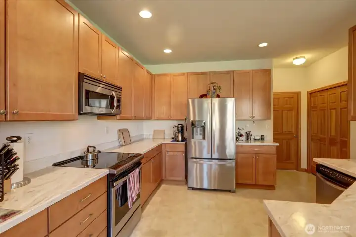 Spacious kitchen featuring Corian counters, extensive cabinetry and the peninsula bar.