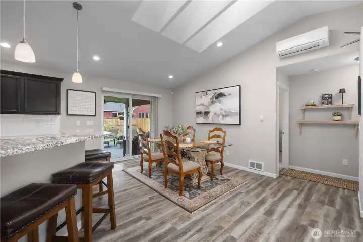 Dine comfortably beside the kitchen with patio access, vaulted ceilings, and a ductless mini-split for efficient comfort.