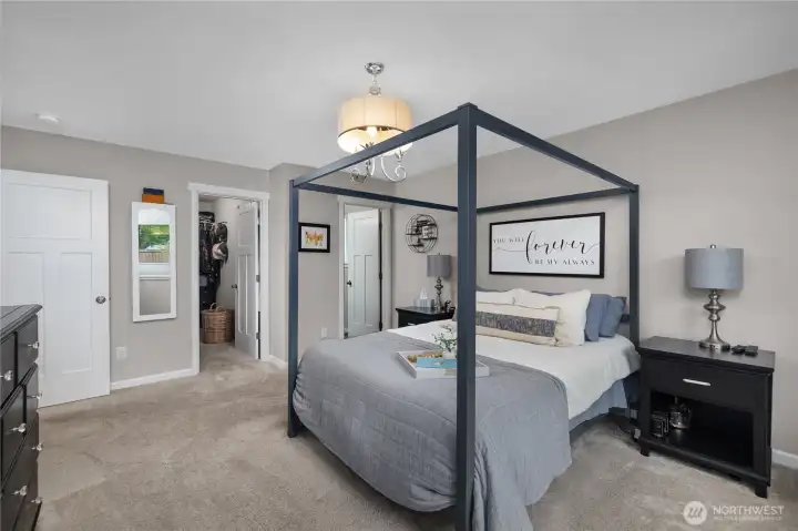 Enjoy the primary suite with room for a larger furniture layout and convenient access to the walk-in closet and bath.