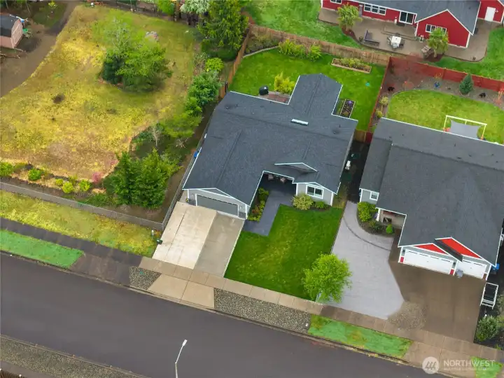 Clean, established street setting with a landscaped yard and neighboring green space.