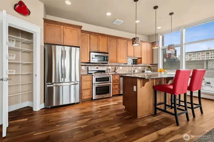 The kitchen pantry door is open along the left here, to show what gret storage you have!