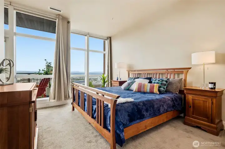 Your primary bedroom suite provide a territorial view toward Mt Rainier, the Port, and points far beyond.