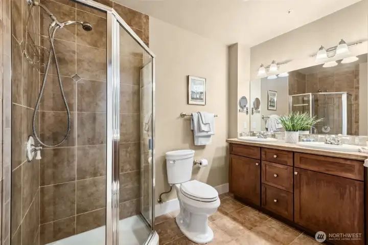 A step in shower plus a dual vanity with a room length mirror is the ideal primary bathroom.