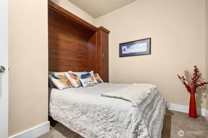 The second bedroom features a wall bed, so invite your guests to spend time with you. This is also a great space for a home office.