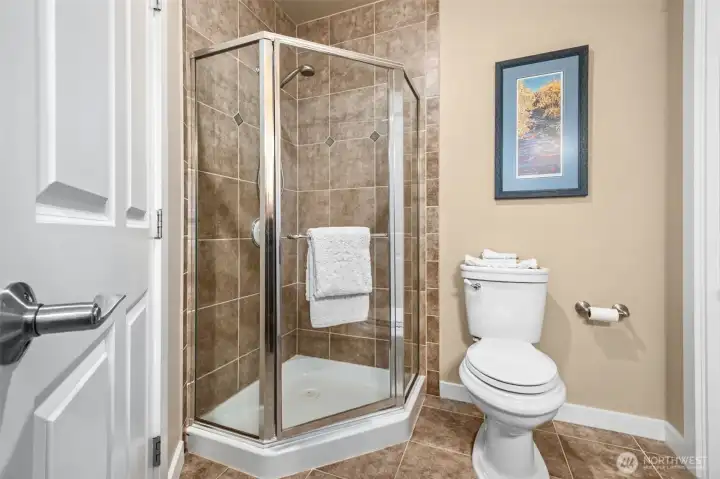 The corner shower stall in the second bathroom is ideal for guests.
