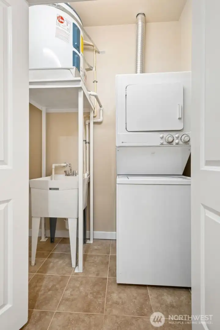 The laundry center in the second bathroom has a utility sink with the full-size water heater perched above.