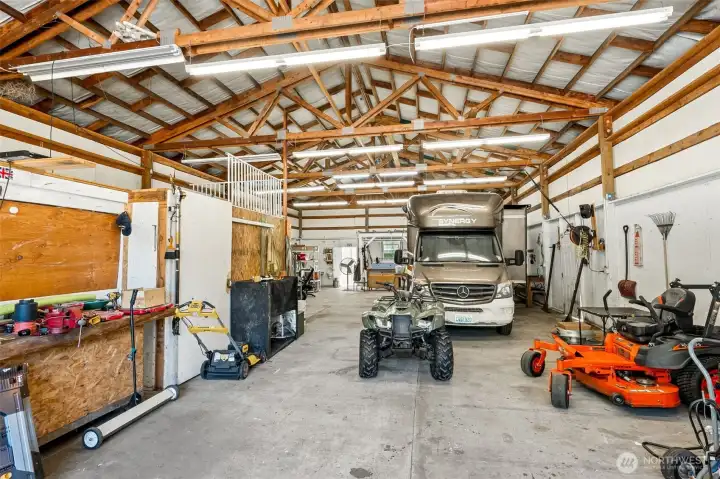If you've been searching for a property with a real shop, welcome home. This incredible 72' x 34' insulated shop delivers approximately 2,450 square feet of flexible workspace with features that are hard to find all in one place. Bright LED lighting, automatic garage door openers, year-round heating and cooling, abundant shelving, a workbench, compactor, walk-in cooler, and a rolling ladder accessing the expansive overhead storage all combine to create an incredibly functional environment. The dedicated bonus room inside the shop offers its own mini-split system, making it ideal as a private office, game room, creative studio, or the ultimate man or woman cave. One feature business owners will especially appreciate is the separate Puget Sound Energy service for the shop, independent from the home's electrical service and water pump, making it much easier to track utility costs for a home-based business, workshop, or commercial hobby.