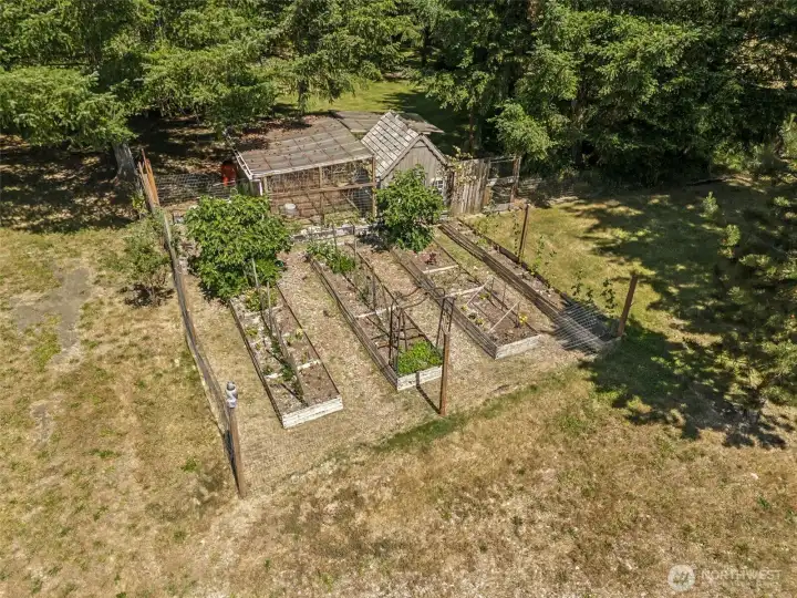 Tucked within its own fenced area, you'll find an impressive collection of homesteading amenities already in place, including raised garden beds, a chicken run, greenhouse storage structure, garden shed, woodshed, and plenty of room to grow your favorite fruits, vegetables, herbs, and flowers. Current owners have already enjoyed harvesting artichokes and other garden treasures from this productive space. Behind the scenes, the private well and pump house help make maintaining the gardens both practical and economical, allowing you to irrigate without relying on costly city water. Whether your dream involves farm-to-table dinners, fresh eggs each morning, or simply spending peaceful afternoons in the garden, this property is ready to support that vision from day one.