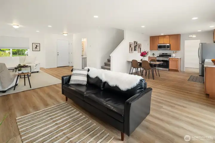 Showing Living room, kitchen, and then entry to Utility room with tons of storage, All new appliances and New Floor on the Main Level