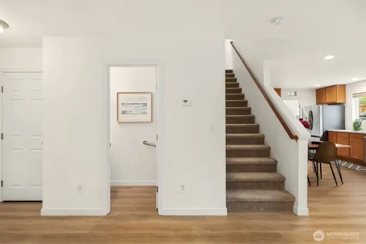 Closet on left side, half bathroom, stairs up to 4 bedrooms, Kitchen on right side,
