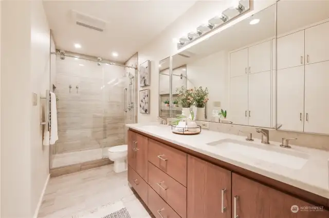 Primary bath was the most recent renovation redesigning it by removing the wall & a walk-in shower, adding a fan & heater, Savoy towel warmer, Strasser cabinet & slab quartz countertops, double undermount sinks.