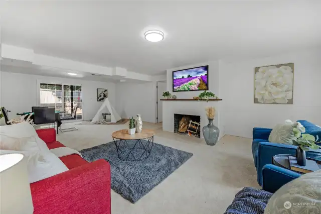 Downstairs rec room, family room. Used as a fifth bedroom in the past.