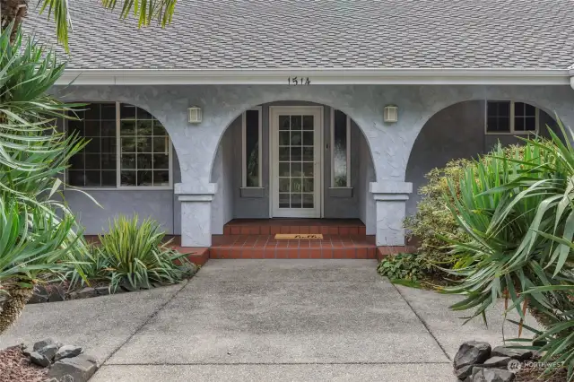 Southwestern style entrance invites old fashioned frontporch sitting!