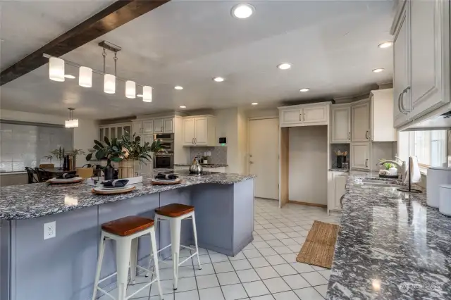 Bright and open kitchen with dining space and island for prep or informal dining