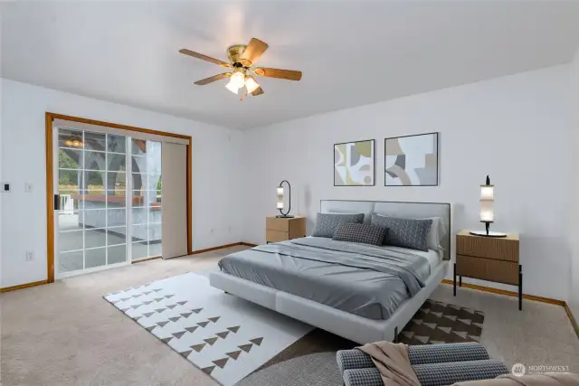 Primary bedroom with slider access to deck and gazebo (virtually staged photo)