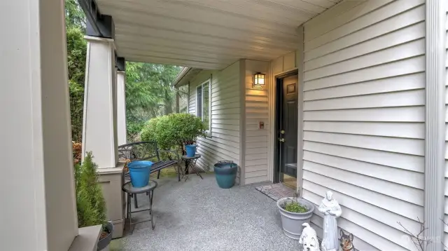 The entry to the home is covered to stay dry plus room for potted plants.